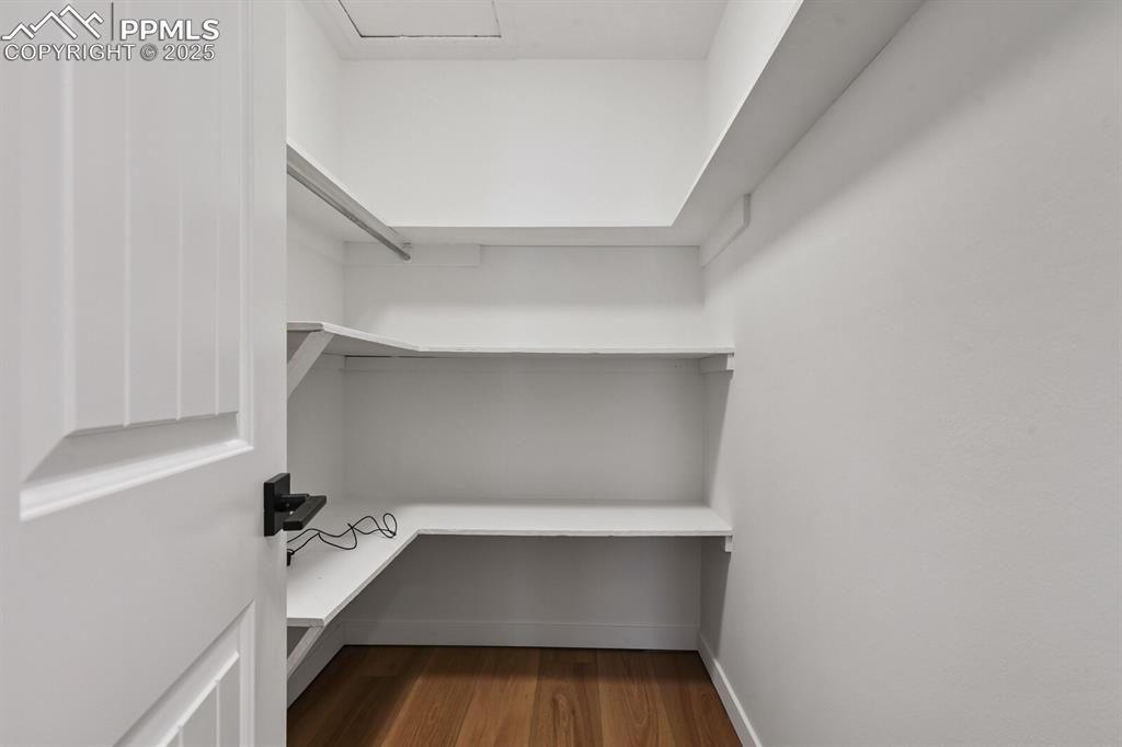 79 Old Broadmoor Road Colorado Springs, CO 80906 - Photo 24 of 27 Walk in closet featuring dark wood-type flooring