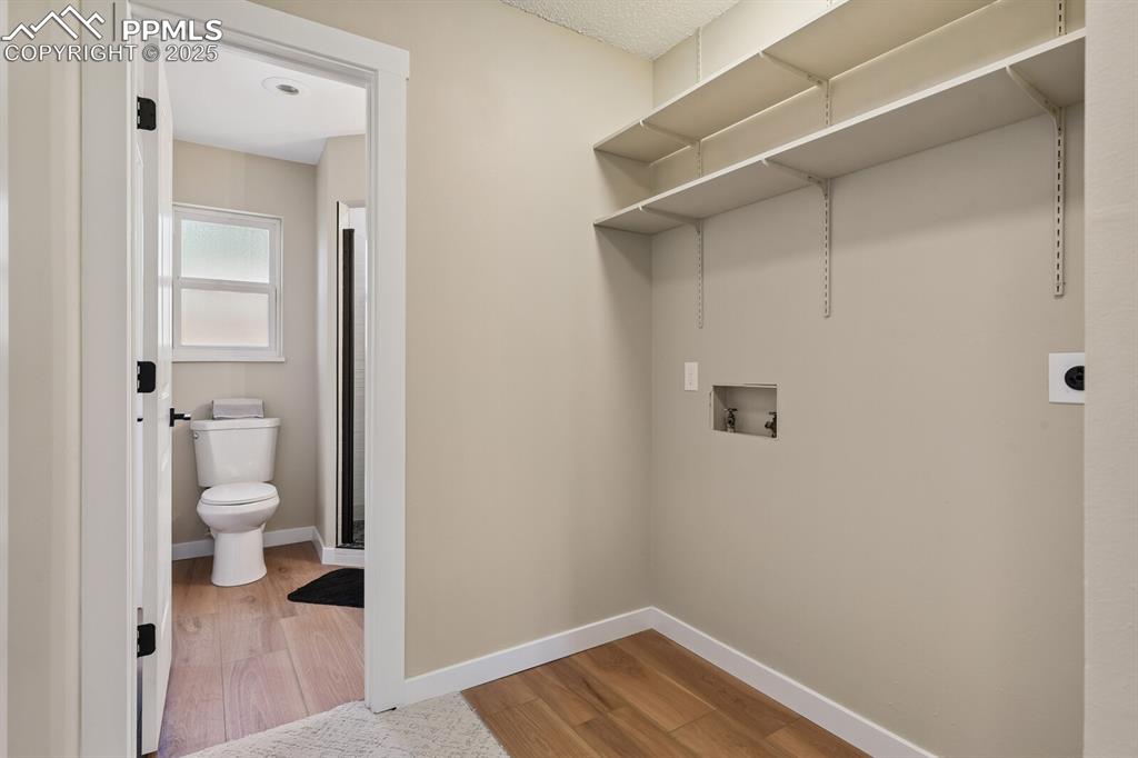 79 Old Broadmoor Road Colorado Springs, CO 80906 - Photo 25 of 27 Laundry room featuring hookup for a washing machine and wood finished floors