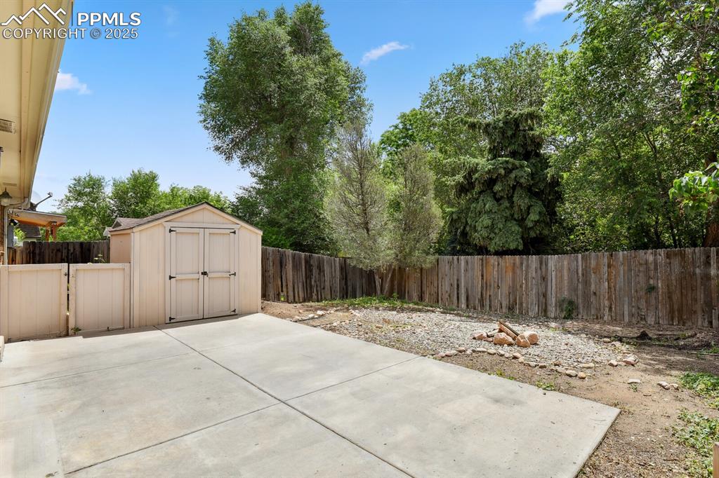 79 Old Broadmoor Road Colorado Springs, CO 80906 - Photo 26 of 27 Fenced backyard with a patio area and a shed