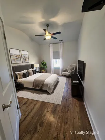 a bedroom with a bed and wooden floor