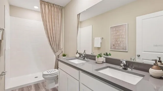 a bathroom with a double vanity sink and a mirror