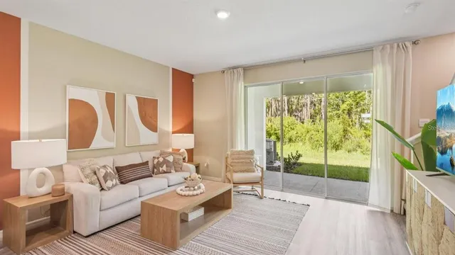 a living room with furniture and a large window