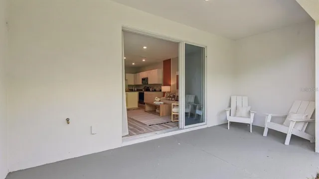 a view of a patio with chairs and a table