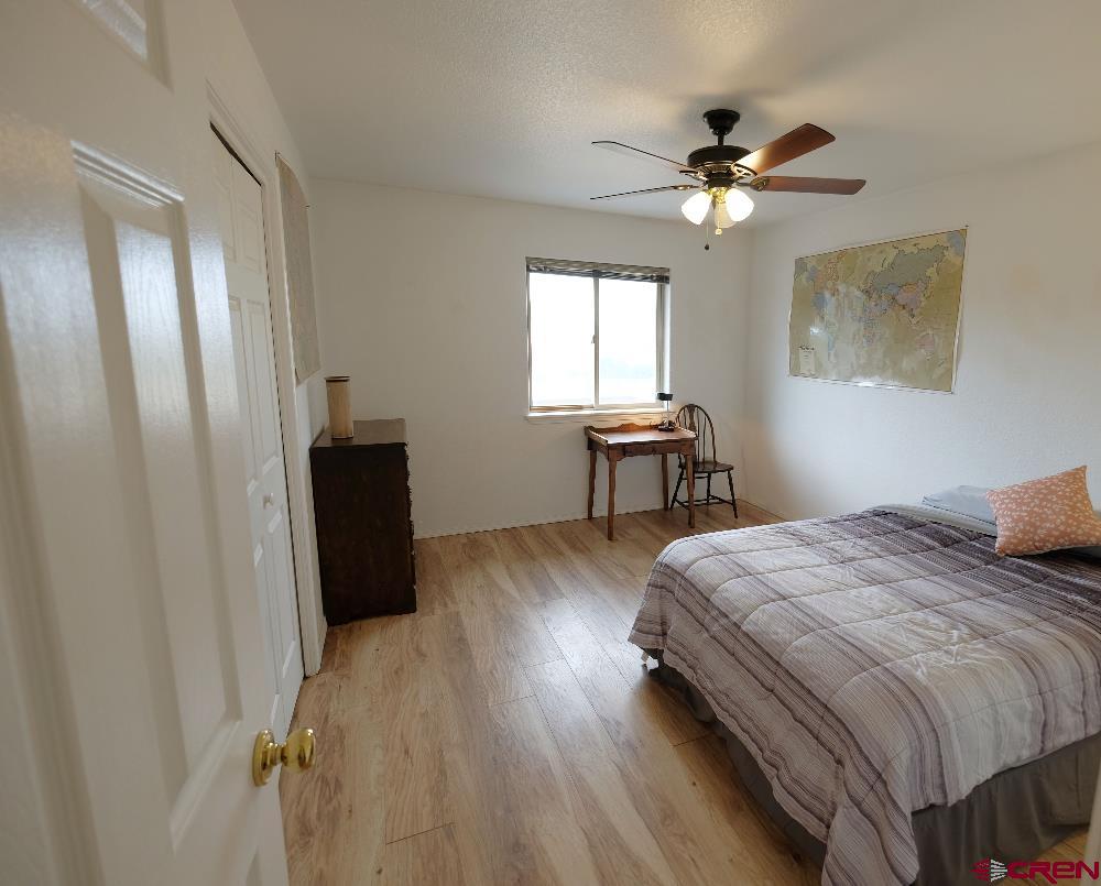14135 N73 Road Montrose, CO 81401 - Photo 14 of 29 a bedroom with a bed and a table