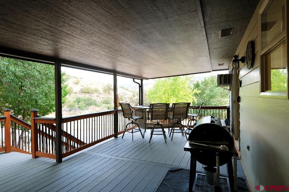14135 N73 Road Montrose, CO 81401 - Photo 21 of 29 a view of a balcony with chairs and wooden floor
