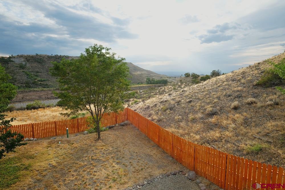 14135 N73 Road Montrose, CO 81401 - Photo 24 of 29 a view of a yard with wooden fence