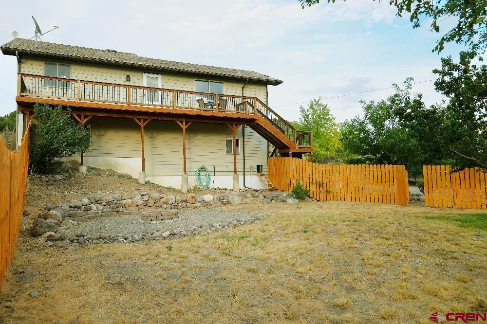 14135 N73 Road Montrose, CO 81401 - Photo 25 of 29 a view of a house with a yard