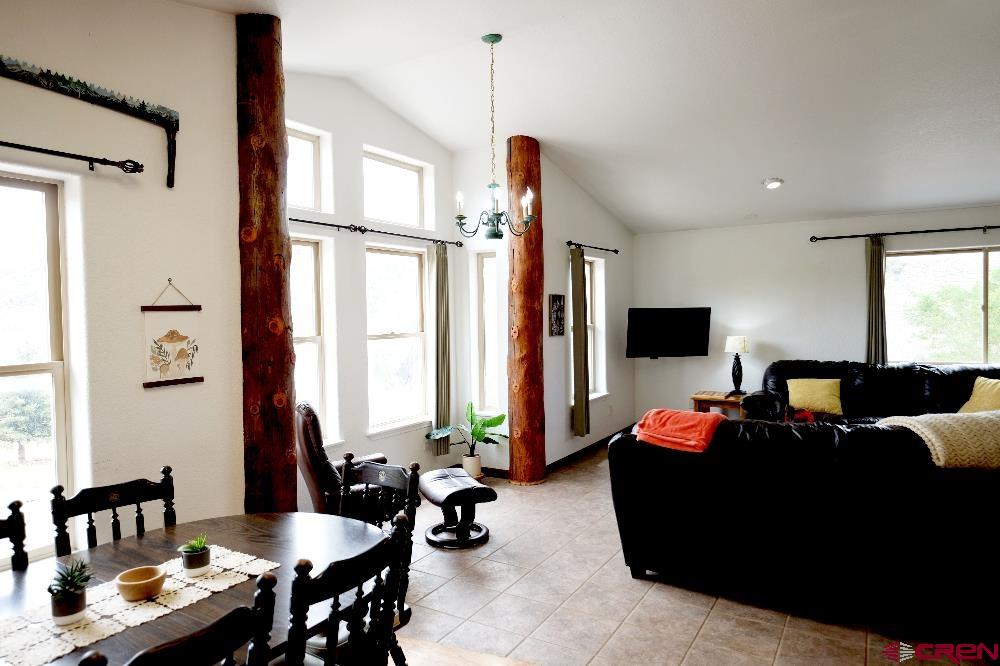 14135 N73 Road Montrose, CO 81401 - Photo 6 of 29 a living room with furniture and a flat screen tv