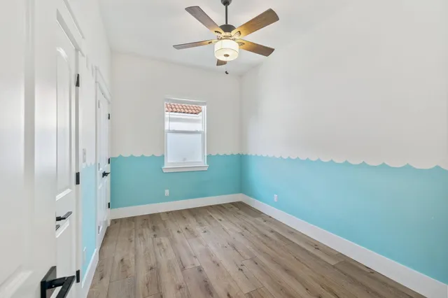 a view of room with window and ceiling fan