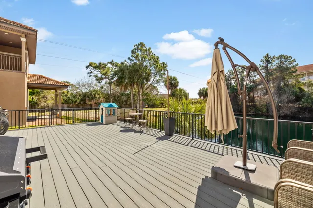 a view of a roof deck with couches and wooden floor