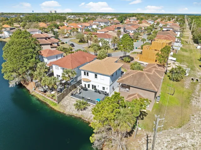 an aerial view of residential houses with outdoor space and river