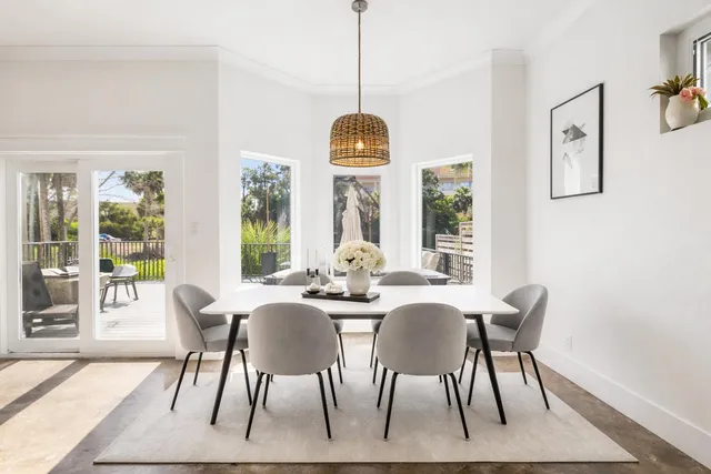 a view of a dining room with furniture wooden floor and windows