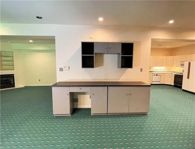 a view of an empty room with a fireplace and a window