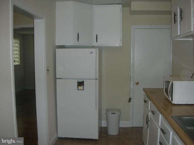 1608 Aberdeen Road Towson, MD 21286 - Photo 11 of 23 a view of cabinets with washer and dryer