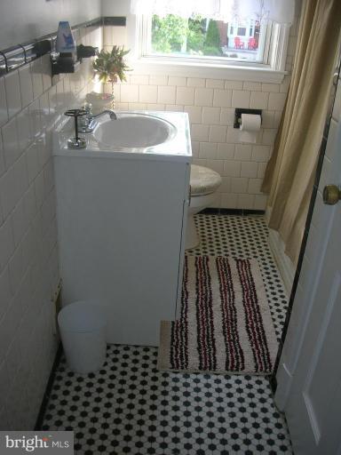 1608 Aberdeen Road Towson, MD 21286 - Photo 14 of 23 a bathroom with a sink and a mirror