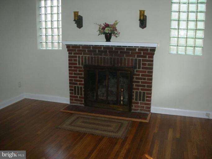 1608 Aberdeen Road Towson, MD 21286 - Photo 10 of 23 a fireplace with a vase on top of it