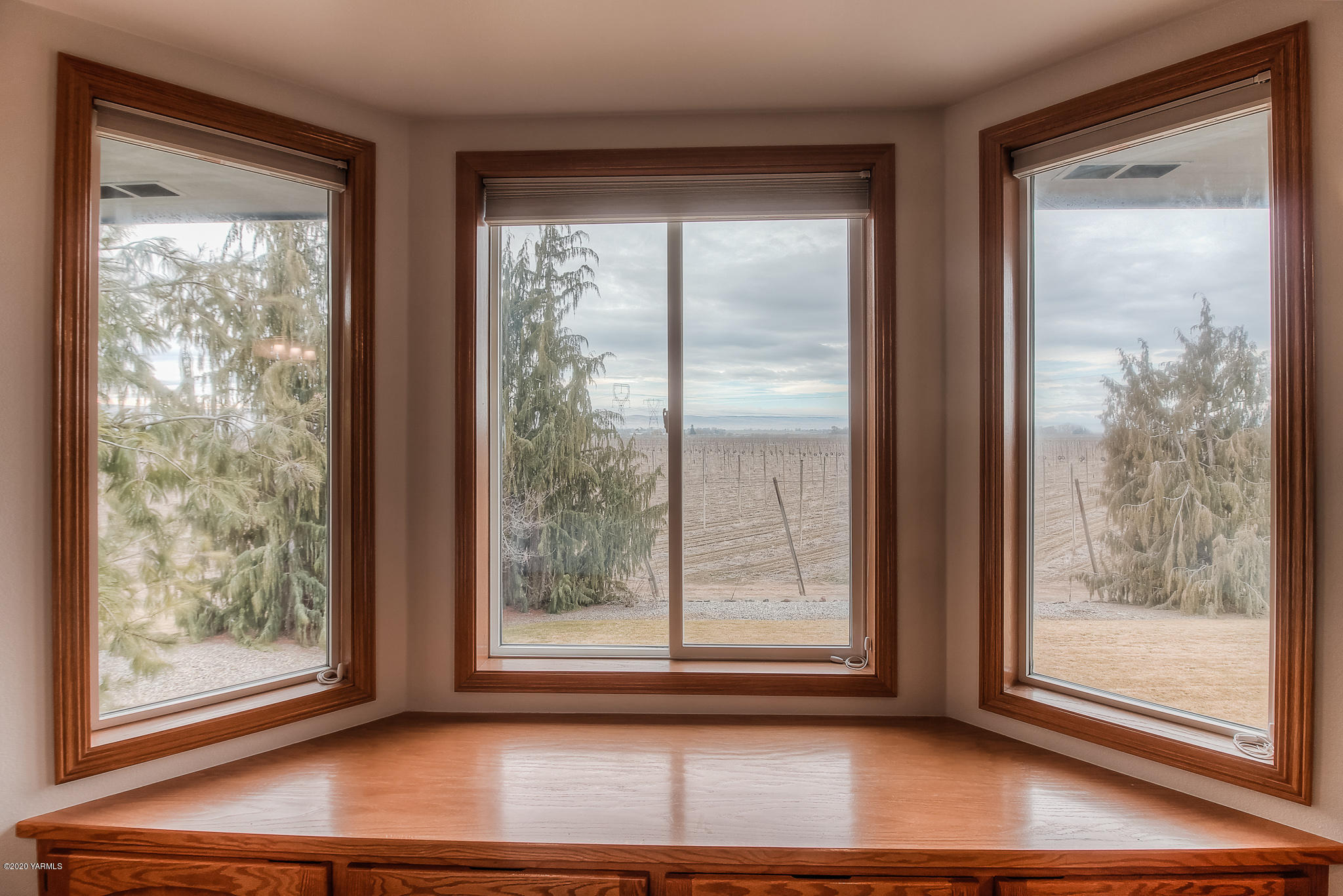 630 Belma Road Grandview, WA 98930 - Photo 22 of 71 a view of a room that has a large window and wooden floor