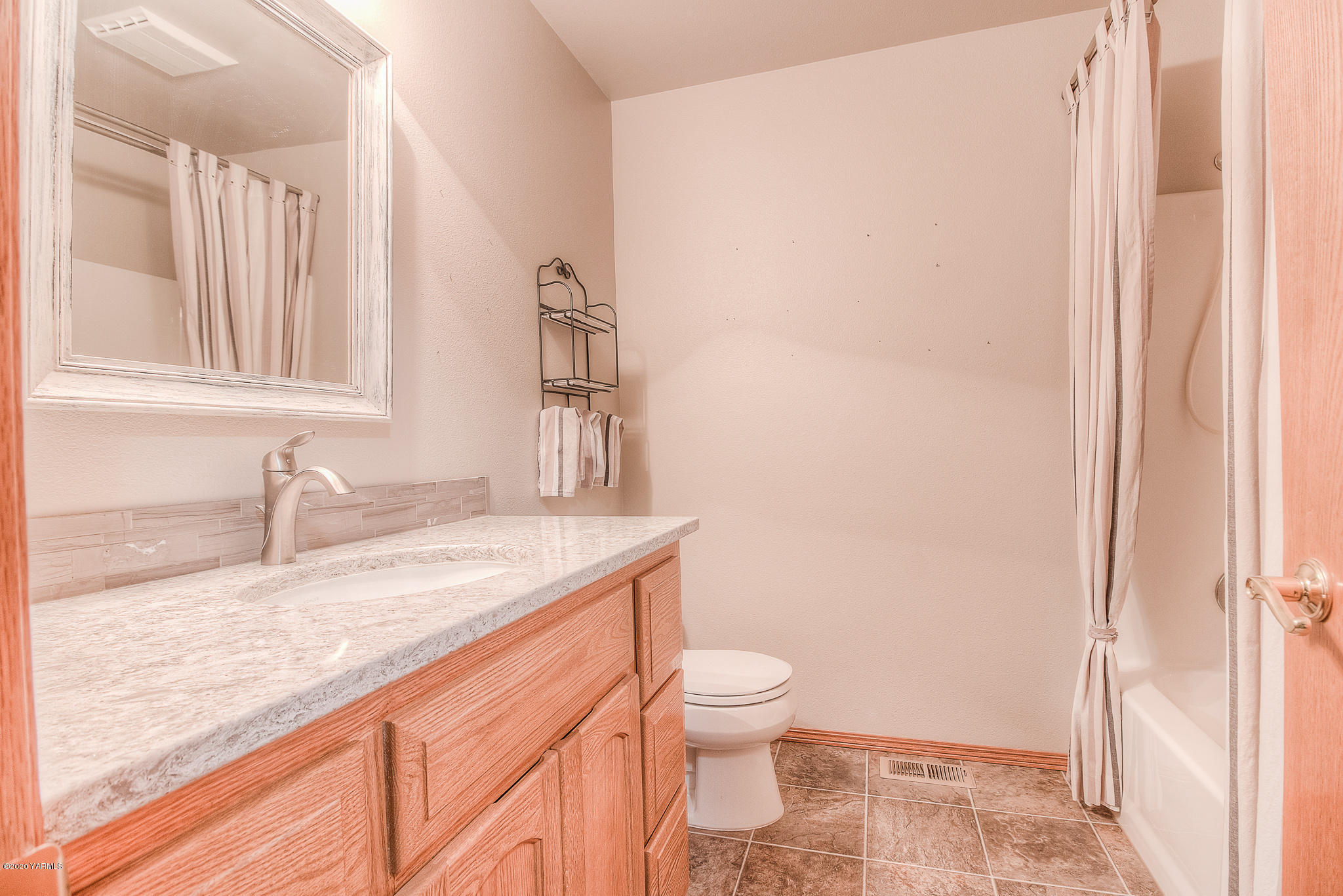 630 Belma Road Grandview, WA 98930 - Photo 25 of 71 a bathroom with a granite countertop sink toilet and shower