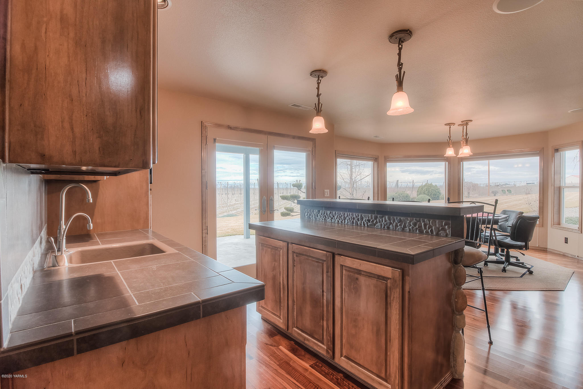 630 Belma Road Grandview, WA 98930 - Photo 31 of 71 a kitchen with stainless steel appliances granite countertop a sink a stove and a wooden floors