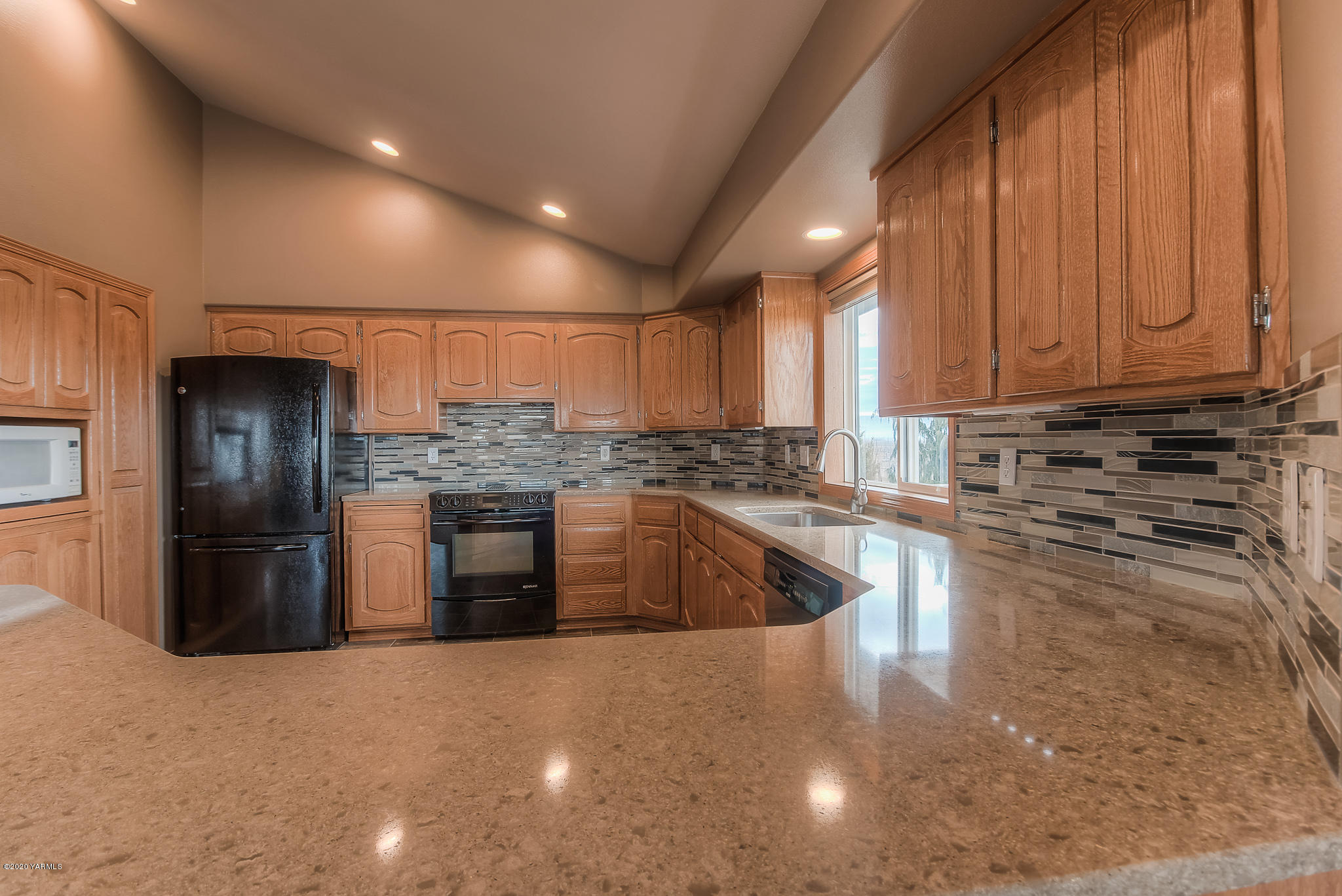 630 Belma Road Grandview, WA 98930 - Photo 6 of 71 a kitchen with stainless steel appliances granite countertop a refrigerator a stove and a sink with wooden cabinets