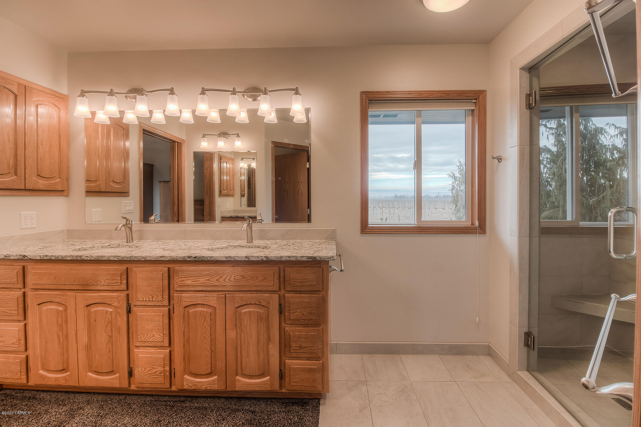 630 Belma Road Grandview, WA 98930 - Photo 62 of 71 a bathroom with a granite countertop sink and a large mirror