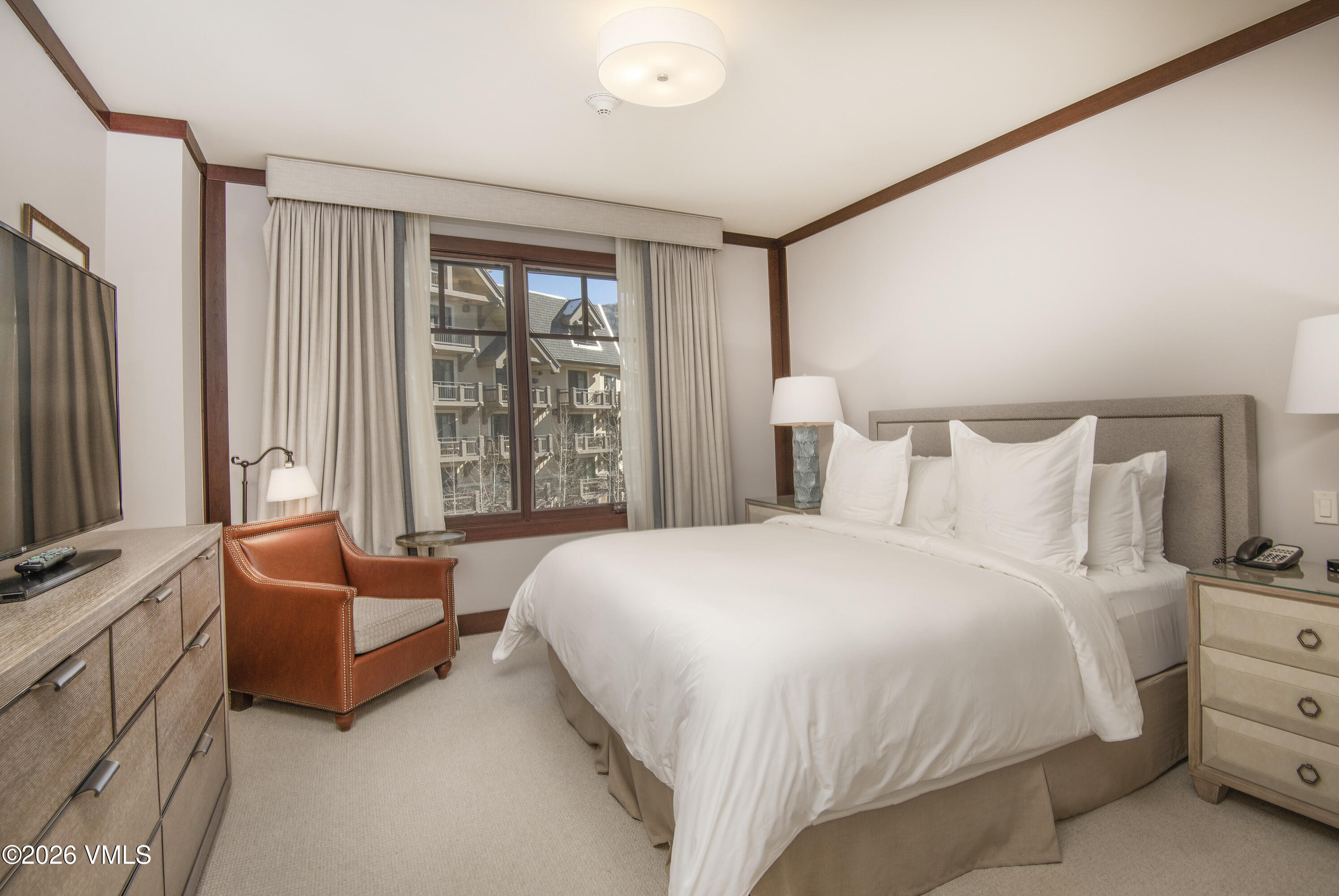 1 Vail Road, Unit 5102C Vail, CO 81657 - Photo 9 of 13 a spacious bedroom with a bed and glass window
