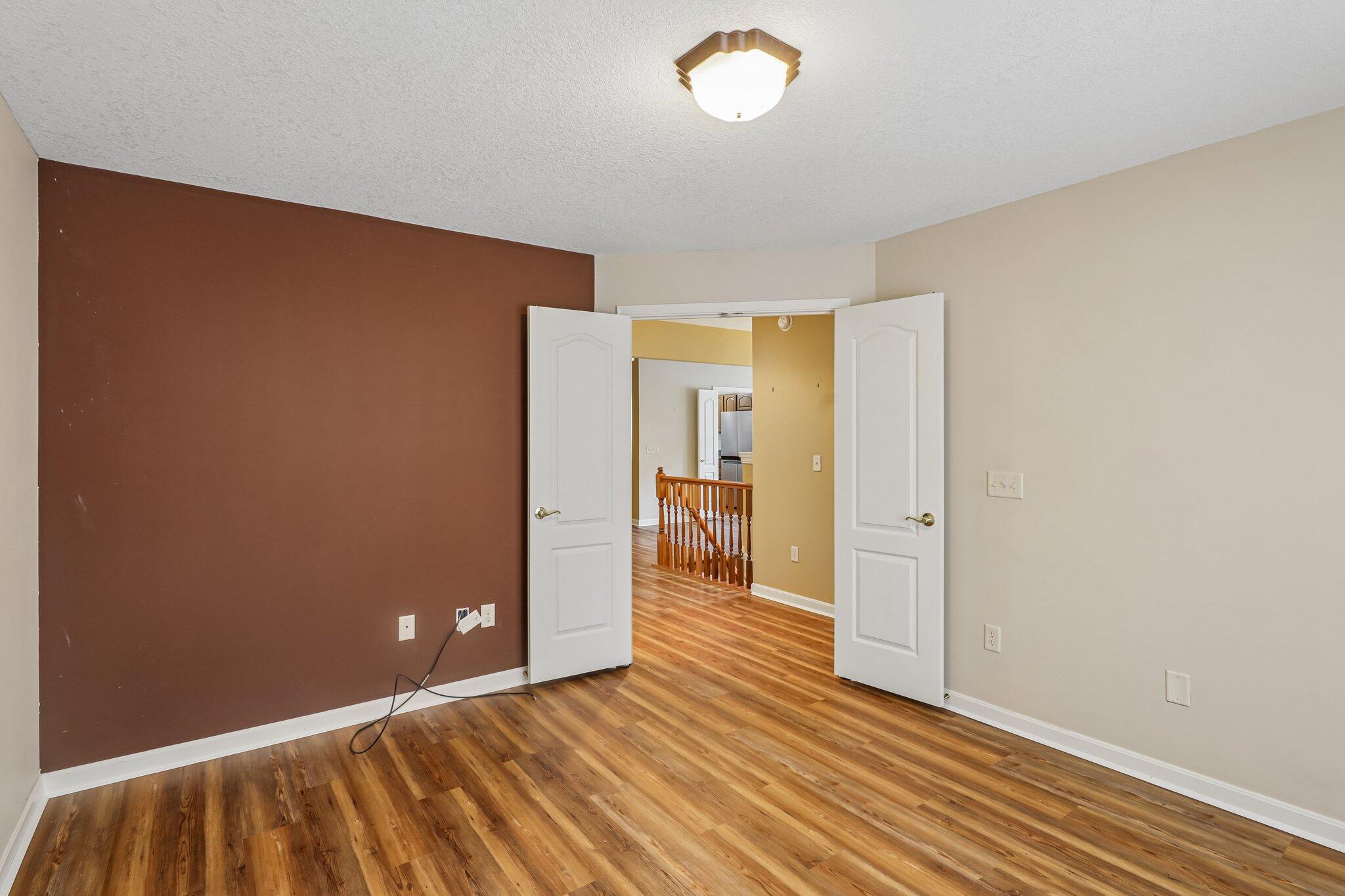 876 Flint Ridge Newport, KY 41076 - Photo 33 of 43 Room with wood-finish flooring, white baseboards, and a neutral wall color