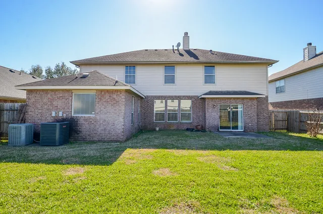 a view of a house with a yard patio and fire pit