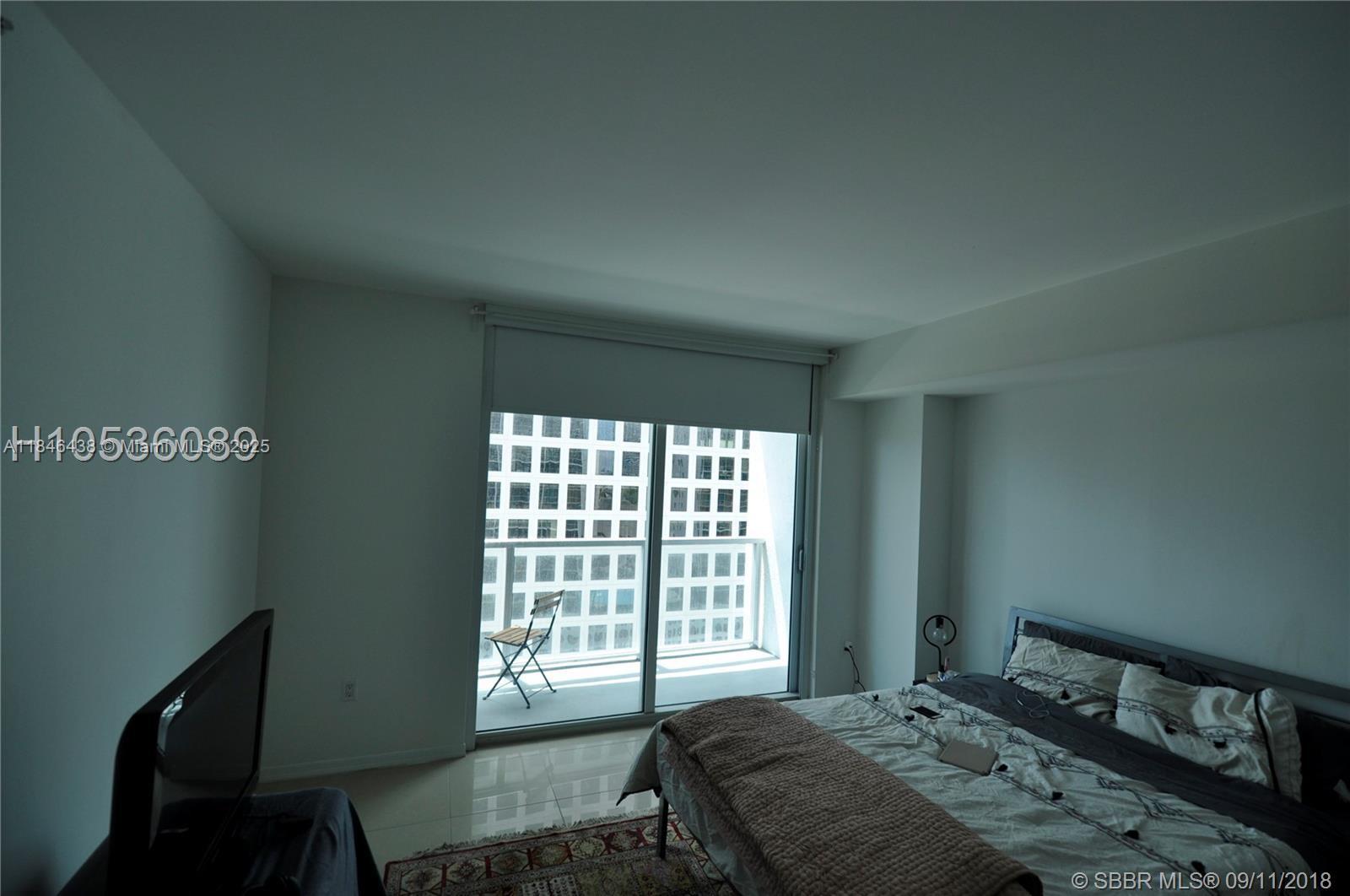 500 Brickell Avenue, Unit 2204 Miami, FL 33131 - Photo 11 of 19 a bedroom with a bed and a window