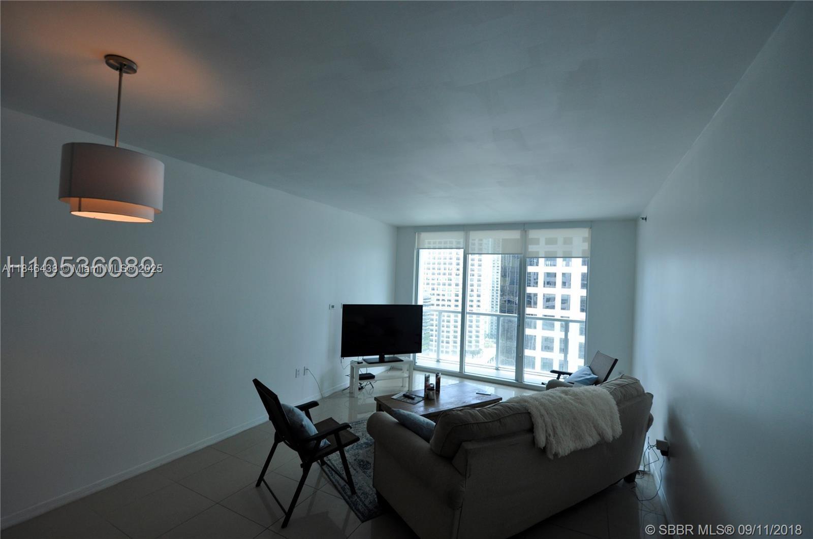 500 Brickell Avenue, Unit 2204 Miami, FL 33131 - Photo 8 of 19 a living room with furniture and a flat screen tv