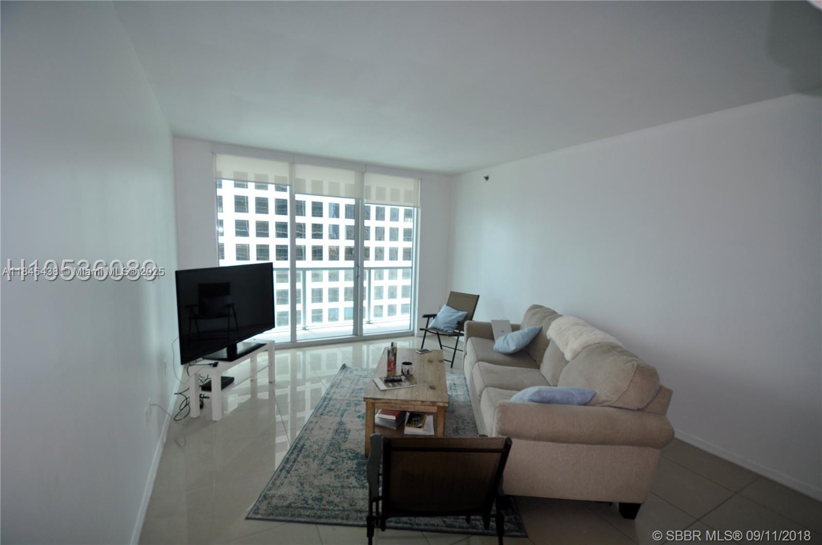 500 Brickell Avenue, Unit 2204 Miami, FL 33131 - Photo 10 of 19 a living room with furniture and a flat screen tv
