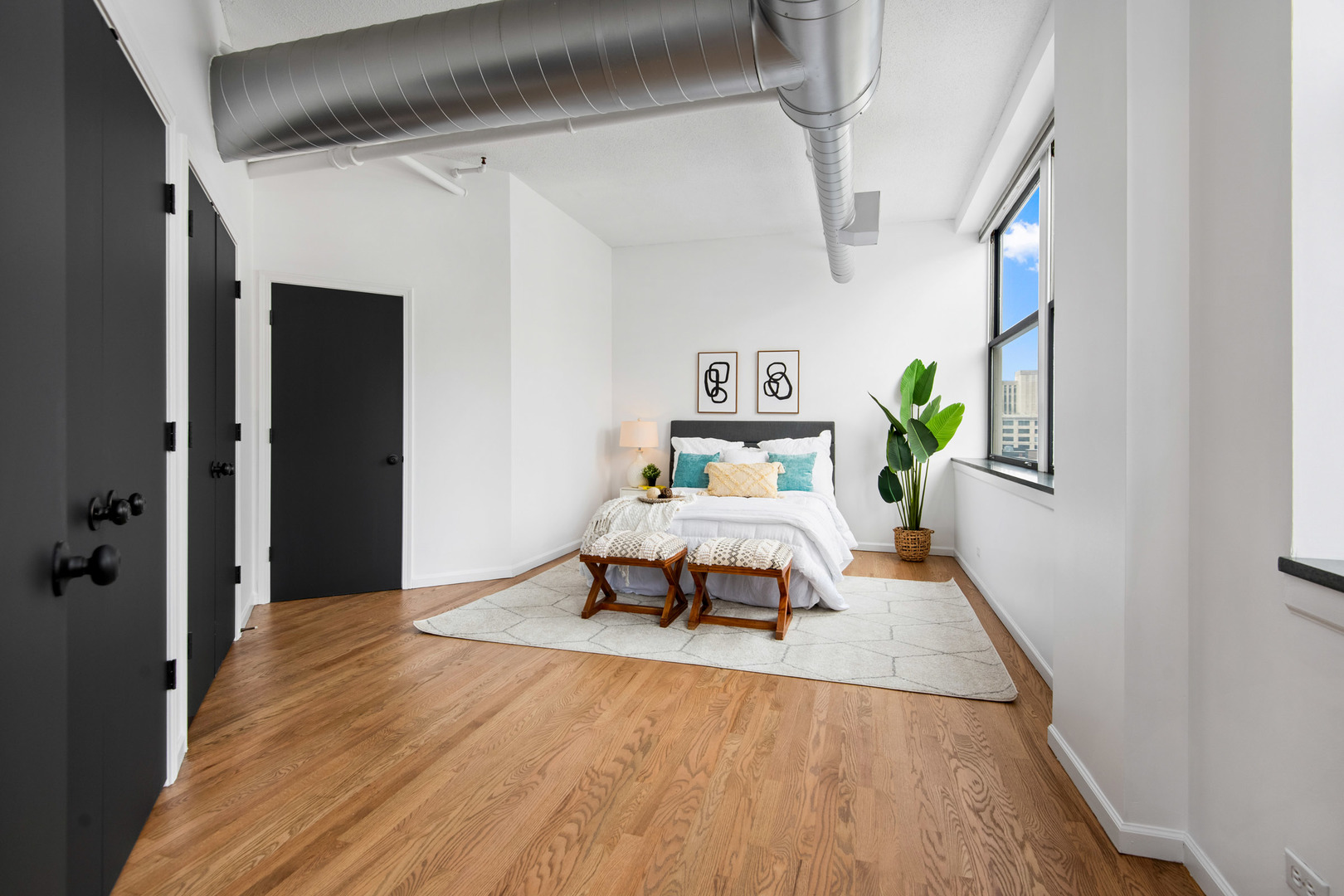 161 West Harrison Street, Unit 802 Chicago, IL 60605 - Photo 16 of 19 a bedroom with a bed and wooden floor