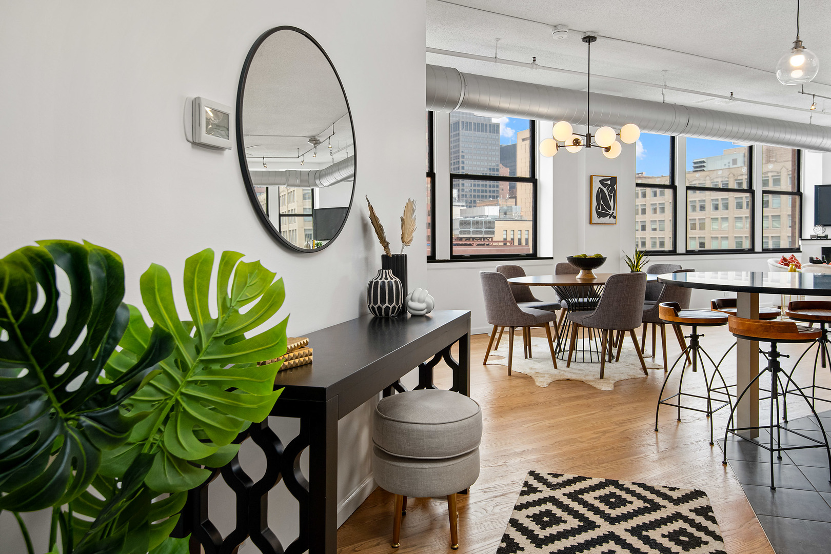 161 West Harrison Street, Unit 802 Chicago, IL 60605 - Photo 2 of 19 a dining room with furniture potted plants and wooden floor