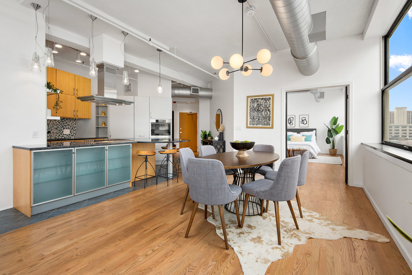 161 West Harrison Street, Unit 802 Chicago, IL 60605 - Photo 9 of 19 a view of a dining room with furniture a chandelier and wooden floor