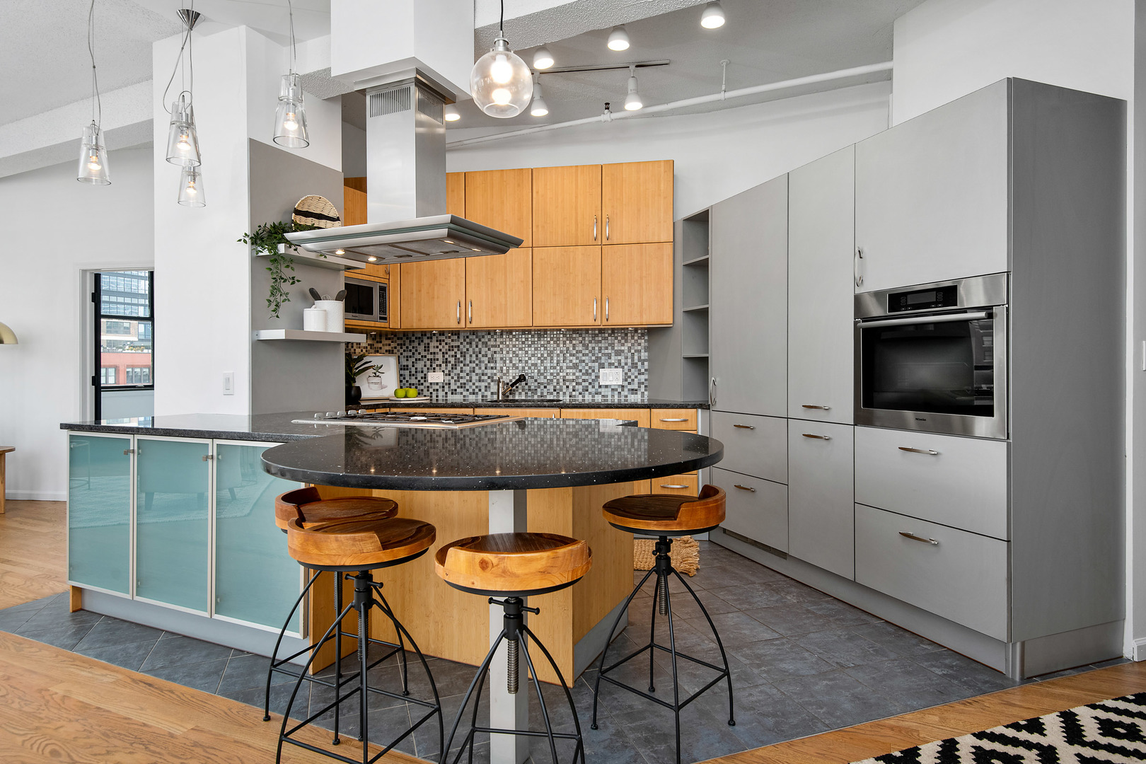 161 West Harrison Street, Unit 802 Chicago, IL 60605 - Photo 10 of 19 a kitchen with stainless steel appliances kitchen island granite countertop a table chairs sink and cabinets