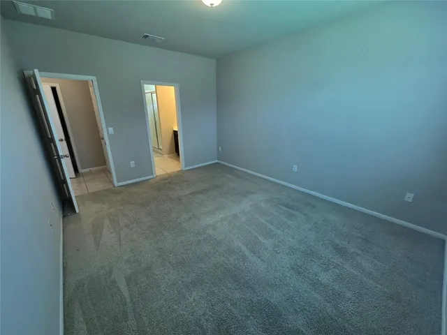 an empty room with closet and mirror