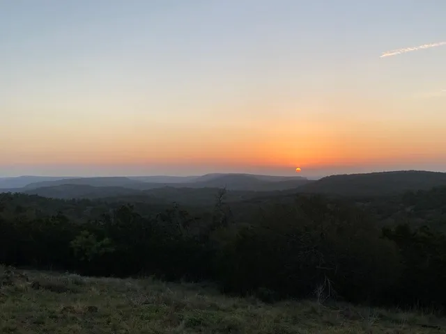 a view of a chairs and table in the backyard
