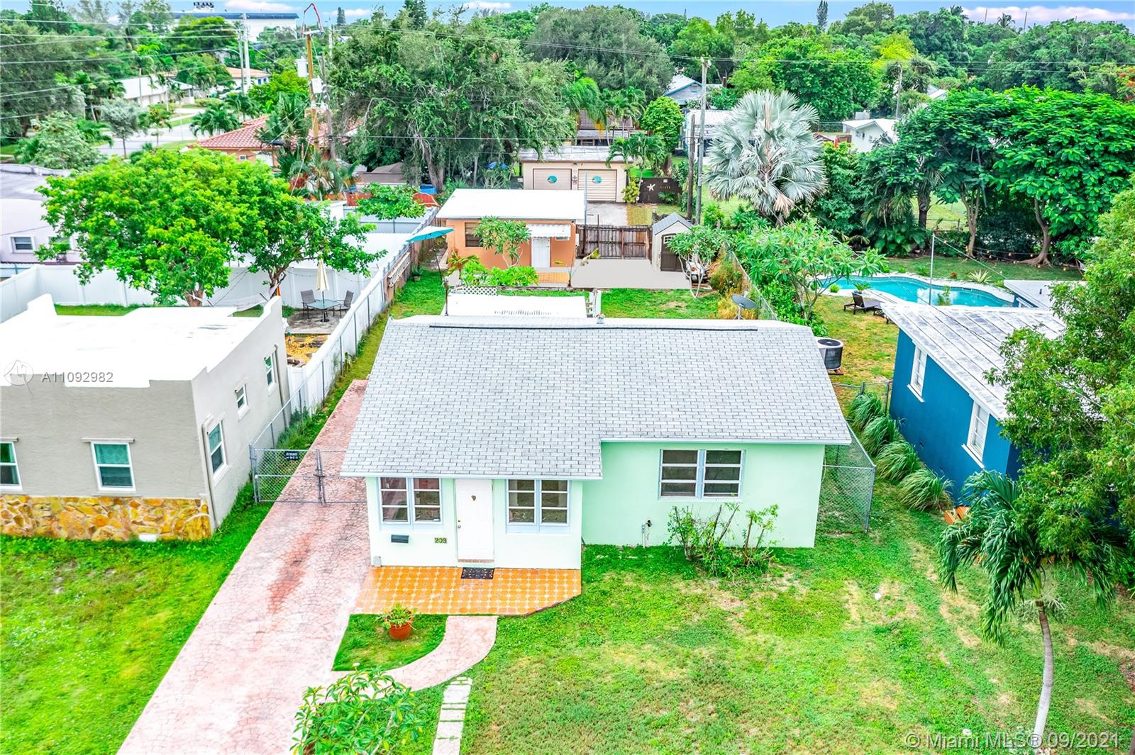 a aerial view of a house with swimming pool and a yard