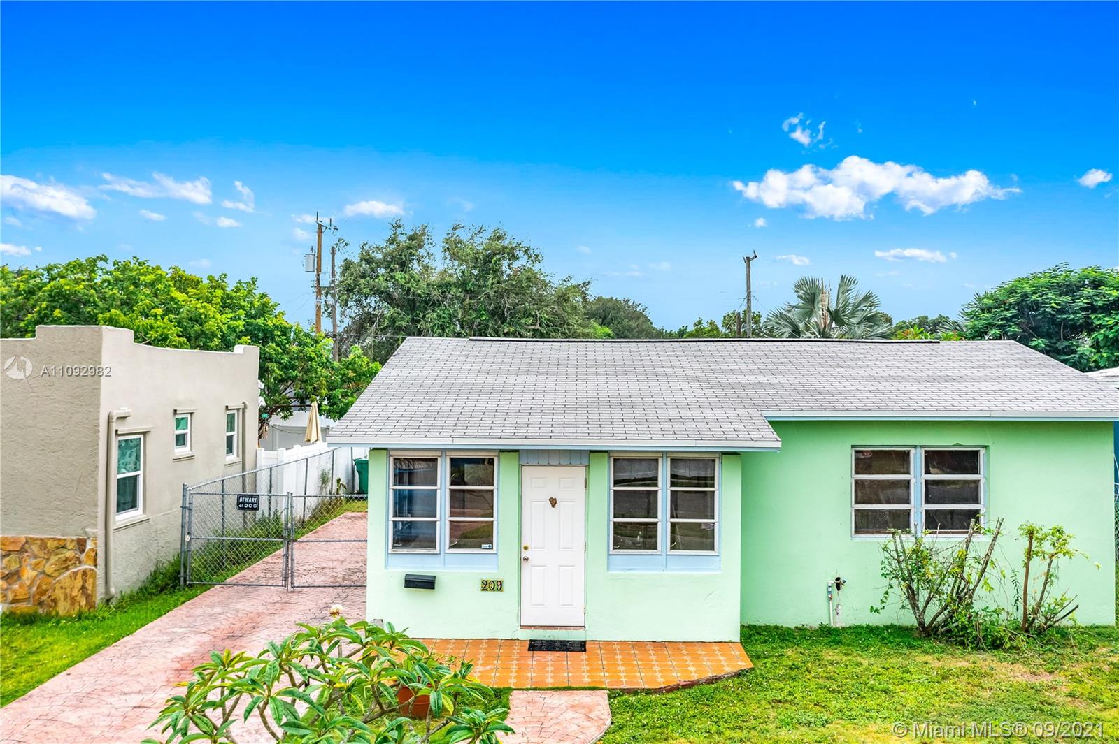 209 Southwest 5th Street Dania Beach, FL 33004 - Photo 2 of 20 a view of a house with a yard and potted plants