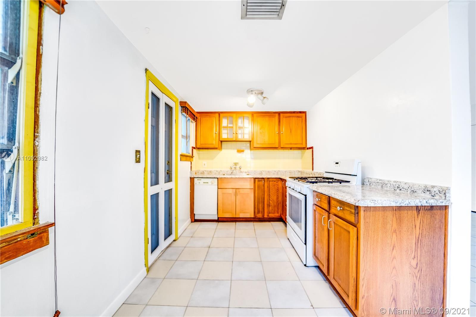209 Southwest 5th Street Dania Beach, FL 33004 - Photo 11 of 20 a kitchen with stainless steel appliances granite countertop a stove and a sink