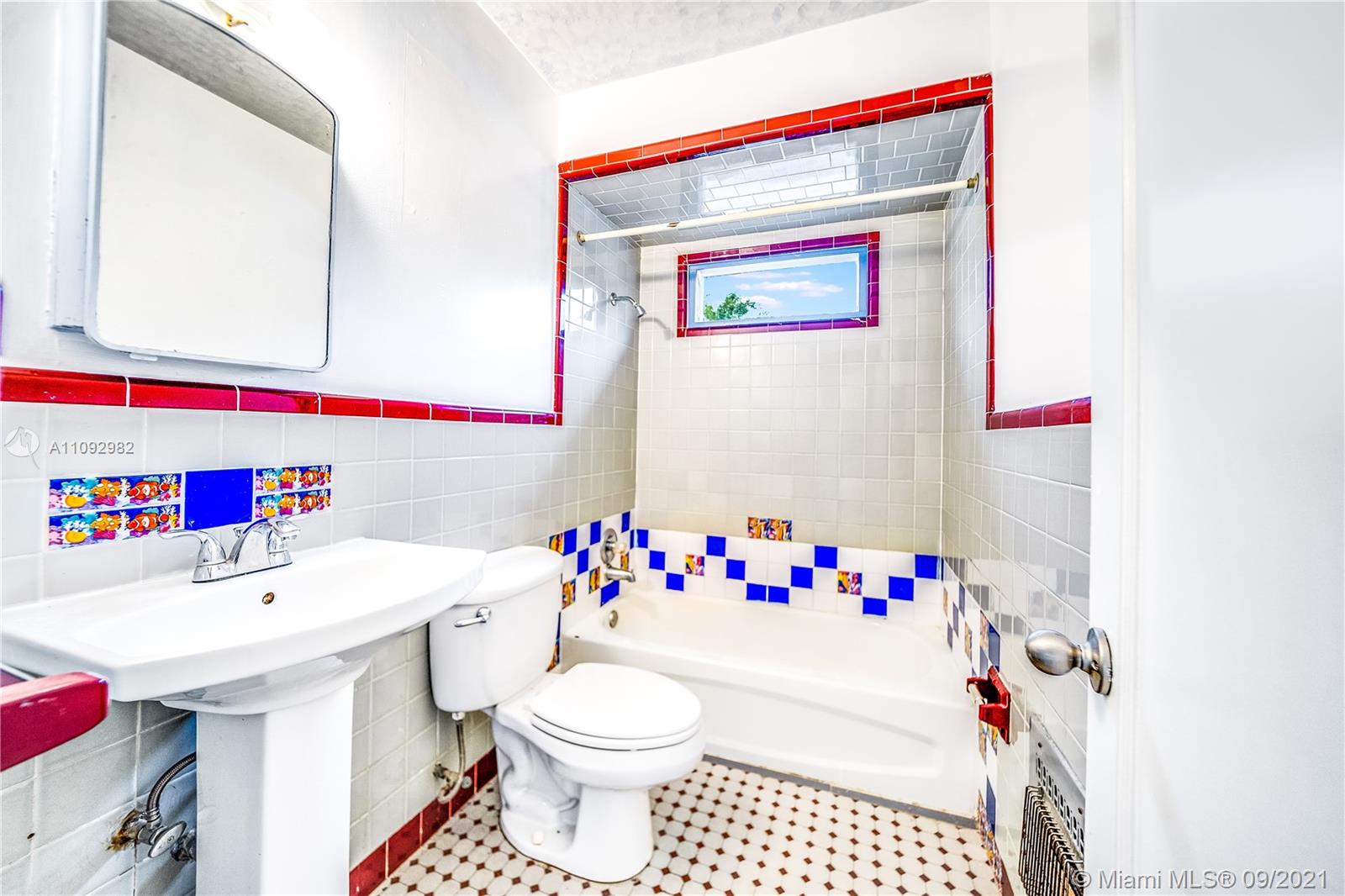 209 Southwest 5th Street Dania Beach, FL 33004 - Photo 17 of 20 a bathroom with a sink and a mirror