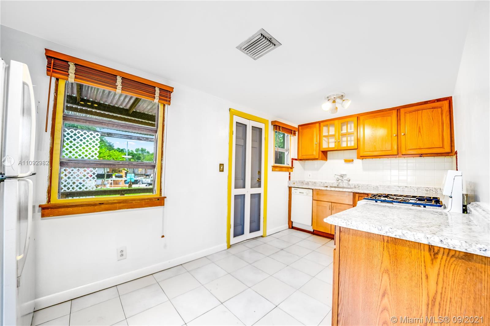209 Southwest 5th Street Dania Beach, FL 33004 - Photo 8 of 20 a view of a kitchen with a stove and a window