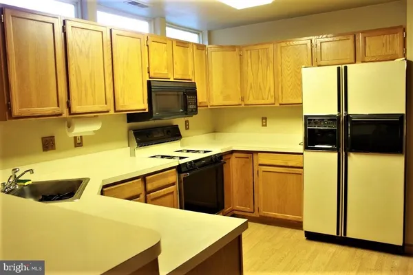 a kitchen with stainless steel appliances a stove sink and microwave