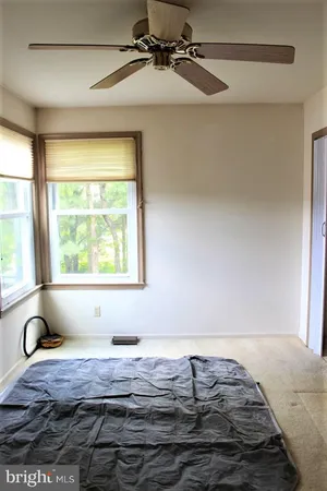 a room with a window and a book shelf
