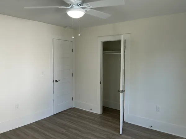 a view of an empty room with wooden floor