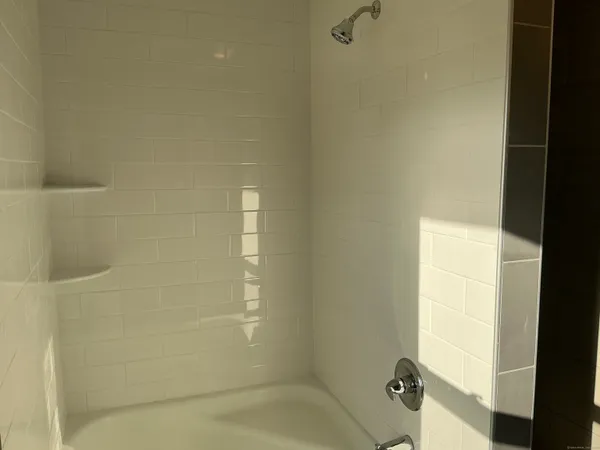 a bath tub sitting next to a white sink and a shower