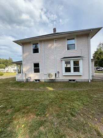 a house view with swimming pool in front of it