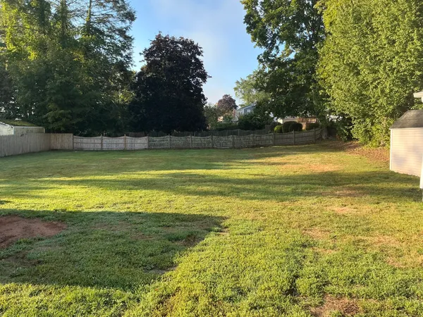 a view of a house with a backyard