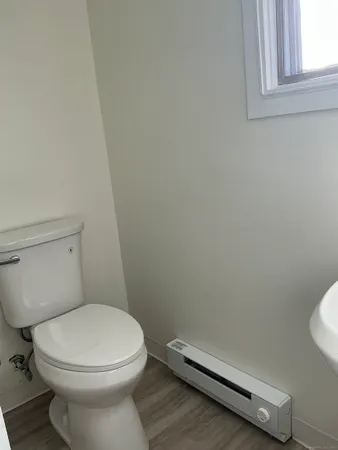 a white toilet sitting next to a bathroom sink