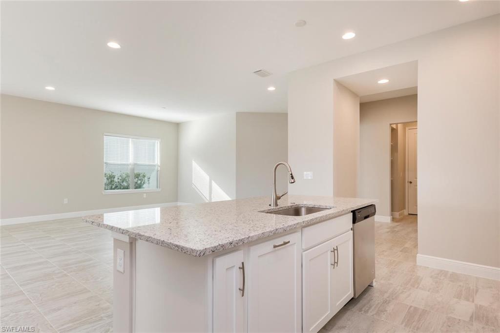 3331 Pilot Circle Naples, FL 34120 - Photo 11 of 28 a kitchen with sink and mirror